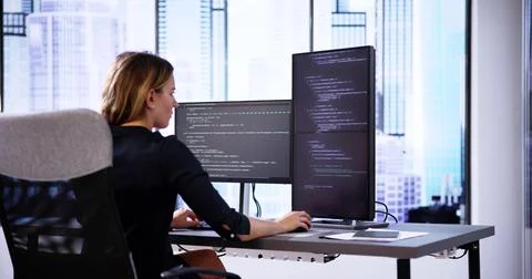Coder Using Computer At Desk 스톡 사진