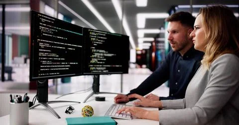 Coder Using Computer At Desk 스톡 사진