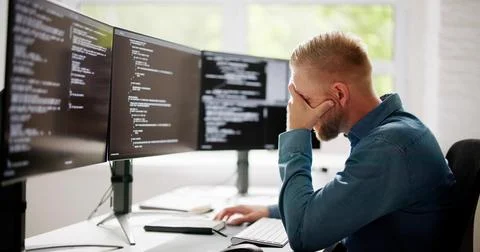 Coder Using Computer At Desk Stock Photos