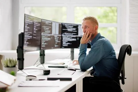 Coder Using Computer At Desk Foto stock
