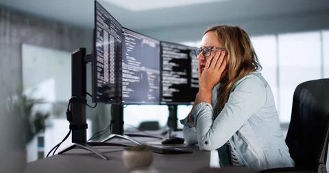 Coder Using Computer At Desk Foto stock