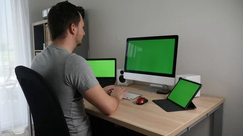 Coder working from home on multiple screens Stock Footage 127456780