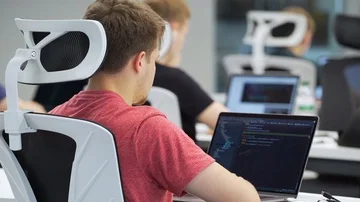 Coder works on laptop in the office Stock Footage 85950321