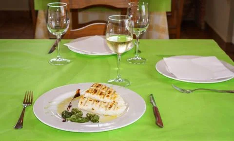 Codfish on plate in a restaurant table Stock Photos