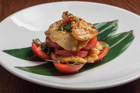 Codfish with tomatoes Stock Photos