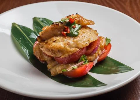 Codfish with tomatoes Stock Photos