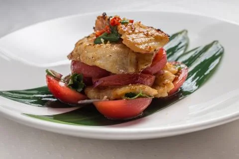 Codfish with tomatoes Stock Photos