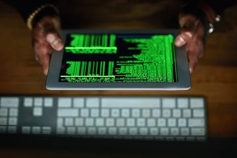 Coding all night long. an unidentifiable hacker cracking a computer code in the 写真素材