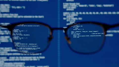 Coding on blue screen computer system thru eye glasses insight vision in data Stock-Footage 142727062