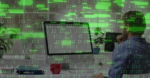 Coding blue-shirted man at desk in office with computer monitor, mug and binary Stock Photos