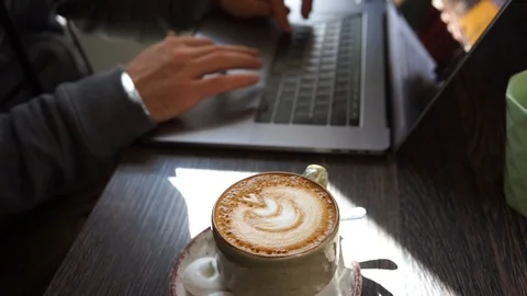 Coding at cafe with coffee and laptop Stock Footage 104516056