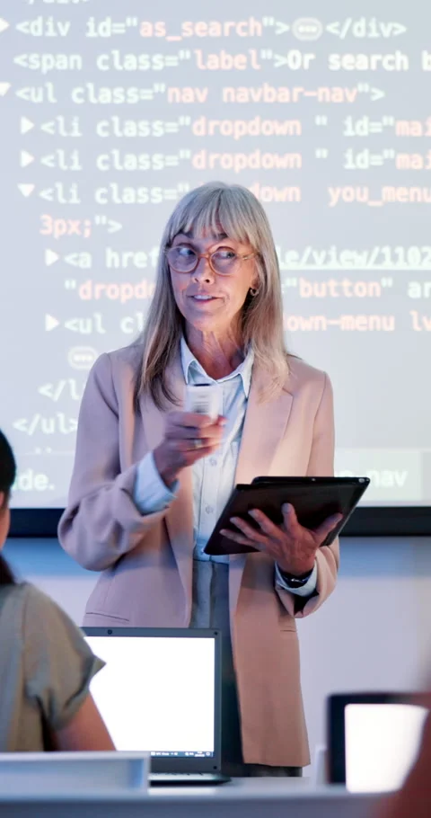 Coding, class and teacher at academy with mature woman, speaker and programming Stock Footage 286403756