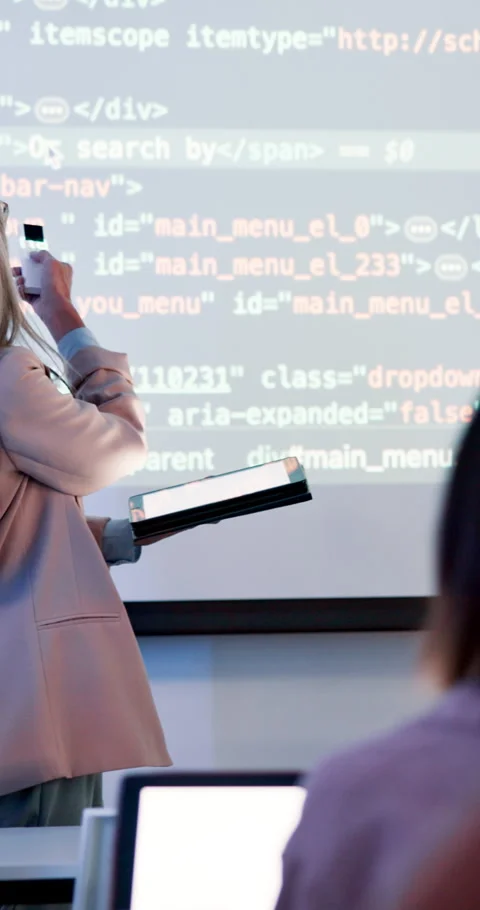 Coding, class and teacher with digital presentation and mature woman at Stock Footage 286403721