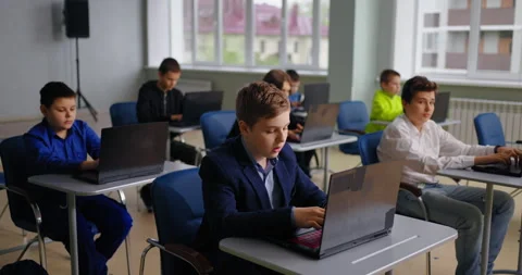 Coding Classes For Middle Schoolers, Boys Sitting At Tables With Laptops In Stock Footage 280178547