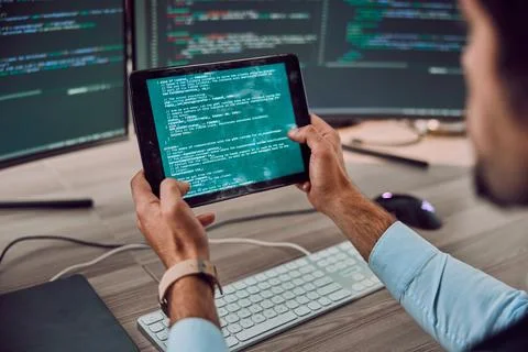 Coding, computer and tablet in hands with man, programmer and software update Stockfoto's