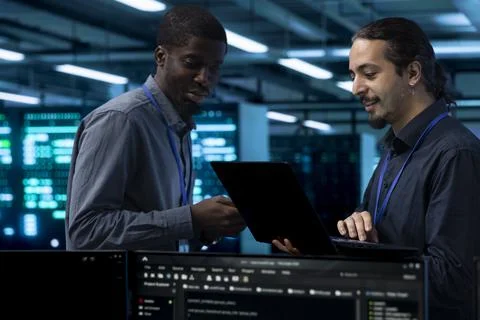 Coding, coworkers and teamwork in server room for troubleshooting Stock Photos