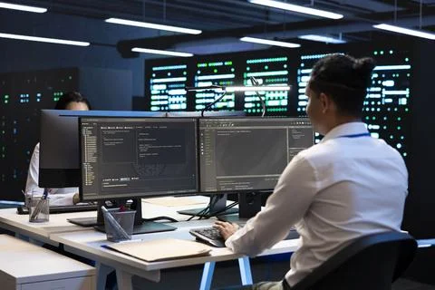 Coding, developer and computer work in data center Stock Photos