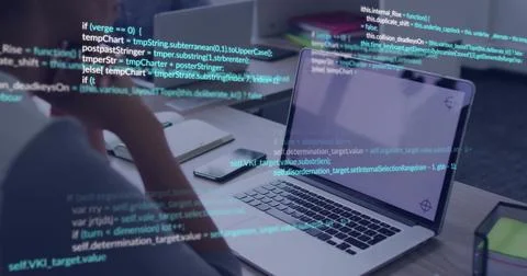 Coding developer resting chin on hand, reviewing code at desk with open laptop Foto stock
