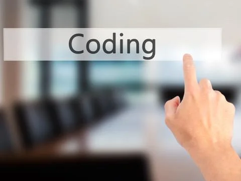 Coding - Hand pressing a button on blurred background concept on visual scree Stockfoto's