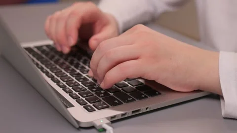 Coding hands work. Person in white sleeve entering commands on silver device Stock-Footage 347880135