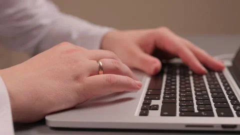 Coding hands work. Person in white sleeve entering commands on silver device Stock-Footage 347880172