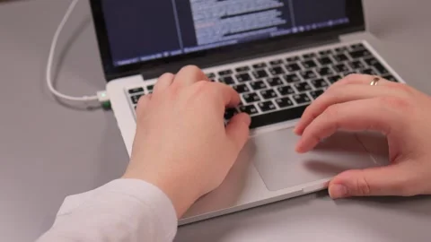 Coding hands work. Person in white sleeve entering commands on silver device Stock-Footage 347880173