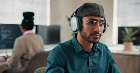 Coding, headphones or man in agency with glasses, radio streaming or debug error Stock Footage 346949915