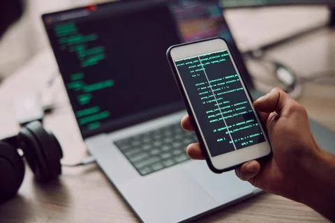 Coding, laptop and phone in hand with man, programmer and software update Stock-Fotos