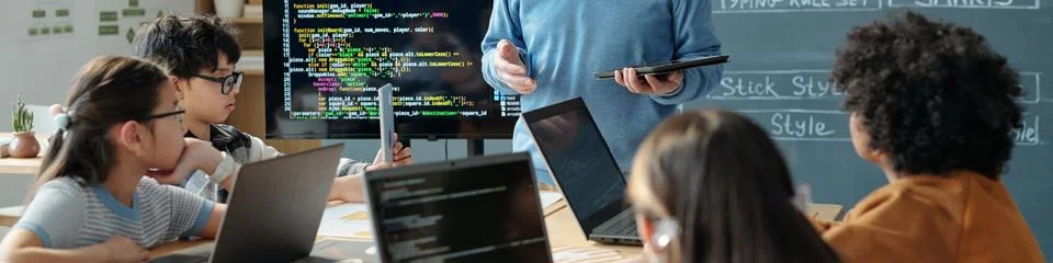 Coding Lessons with Teacher Explaining and Students Listening Stock Photos