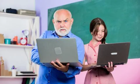 Coding is my spirit. new technology in learning. small girl with man tutor study 스톡 사진