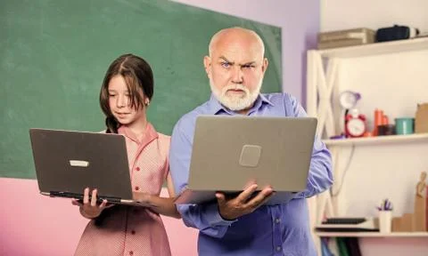 Coding is my spirit. new technology in learning. small girl with man tutor study 写真素材