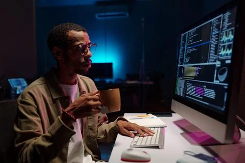 Coding at Night in Modern Office Environment 写真素材