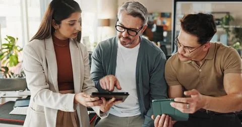 Coding, people and tablet in office for help, advice and problem solving in Stock Photos