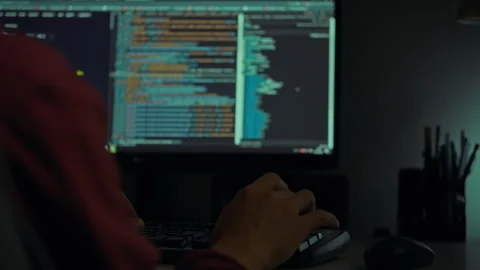 Coding session at night with hands entering commands on a computer keyboard Stock Footage 297711281