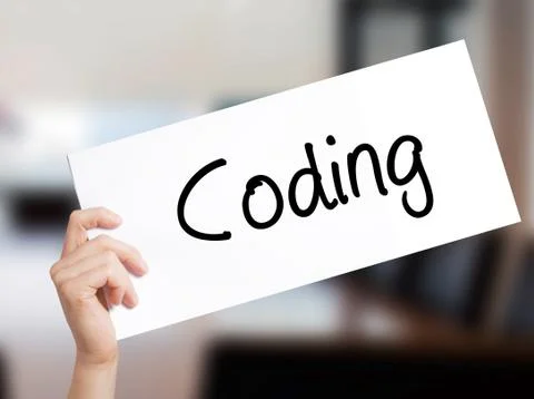 Coding Sign on white paper. Man Hand Holding Paper with text. Isolated on Off 写真素材