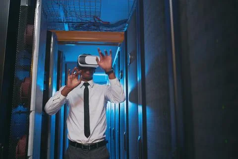 Coding in simulation is fun. a young IT specialist standing alone in the server Stockfoto's