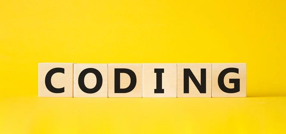 Coding symbol. Concept word Coding on wooden cubes. Beautiful yellow backgr.. Foto stock