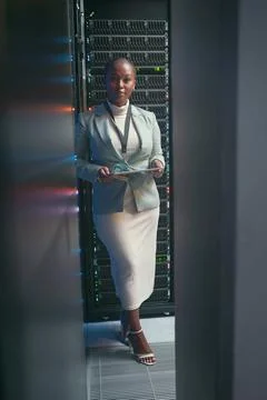 Coding, tablet and portrait of black woman in server room for database Stock Photos