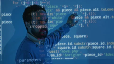 Coding Teacher Pointing to Algorithm on Board in Blue Projector Light Stock-Footage 307269744