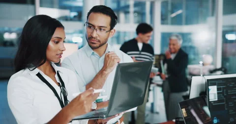 Coding team, laptop and people talking in office for help, web development and Stock Footage 308996854
