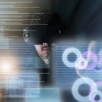 Coding in the virtual world. a young computer programmer wearing a vr headset Foto stock