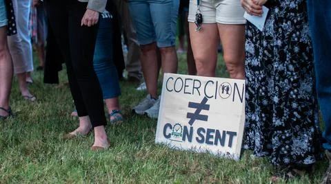 Coercion does not equal consent protest sign laid at feet of protesters Stock Photos