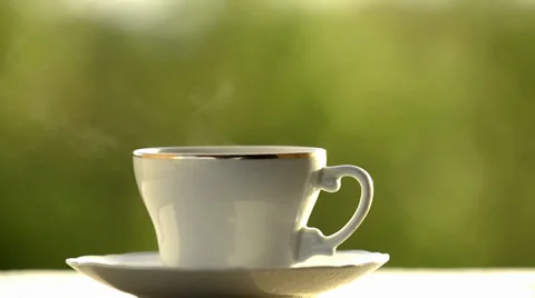 Cofee cup  against a green background Stock Footage 34280874