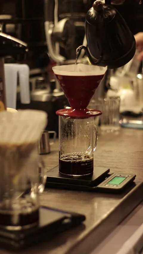 Coffe barista working to make a coffe. Hand drip coffeeTourists with drip coffee Stock Footage 161617811