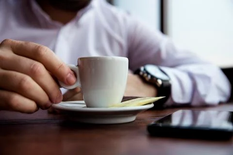 Coffe Cup Held by a Man in the Caffee Bar Stock Photos