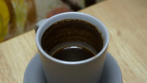 Coffe cup with leftover coffee grounds from inside, standing on the wooden table Stock-Footage 257306049