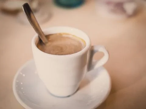 Coffe cup with milk on a table Stock Photos