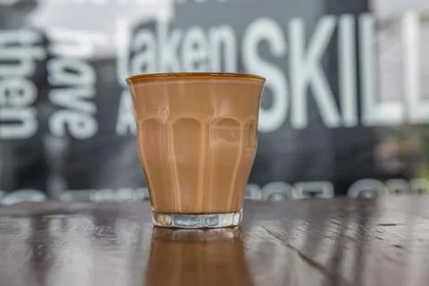 Coffe latte cup on a wood table Stock Photos