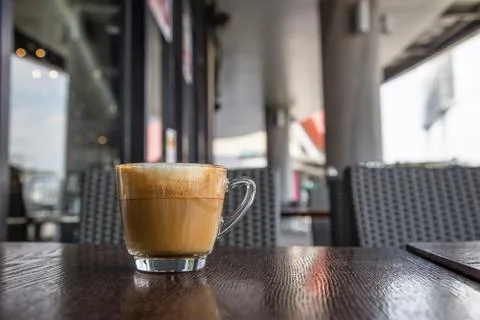 Coffe latte cup on a wood table Stock Photos