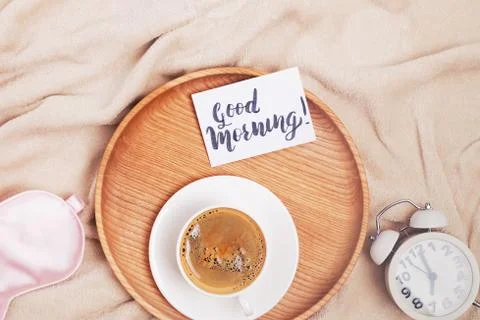 Coffee, alarm clock and note with text Good Morning, top view Foto stock